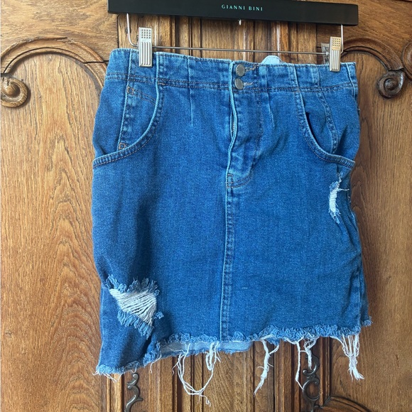 Free People distressed denim mini skirt with a buckle back and raw hem. - Picture 2 of 16